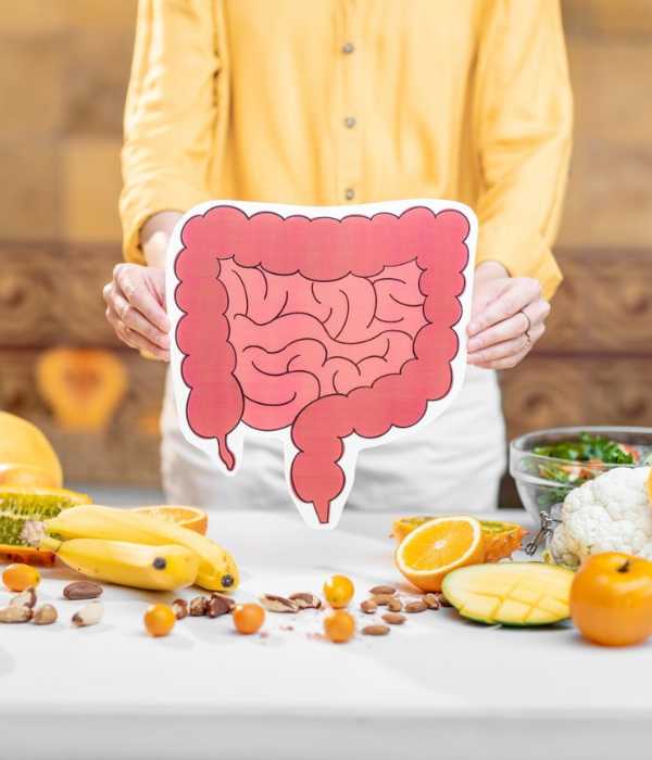 A woman holds a drawing of the large and small intestines.