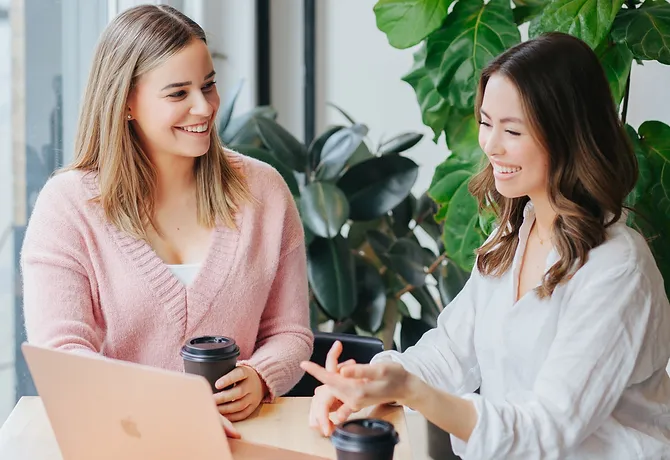 Dietitians Alex Inman and Stephanie Dang laugh together.