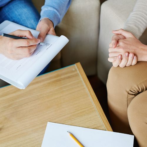 A dietitian sits with their client.