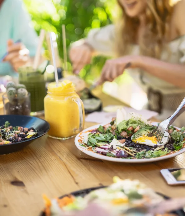 People sit around a table and eat breakfast.