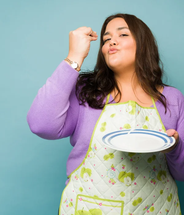 A woman holds an empty plate.